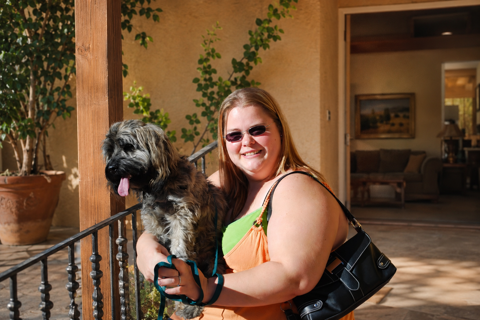 Max being held on the terrace of a warm family home